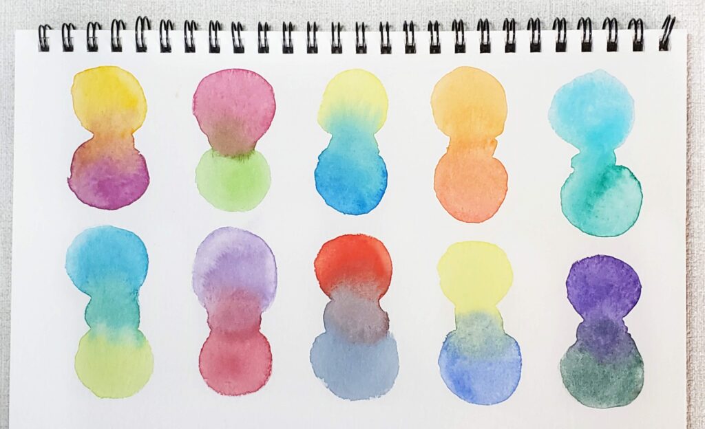 There is an image of colour mixes using the Paul Rubens 4th generation watercolors. There are two rows on the paper, and on each row there are 5 different colour combinations. Each combination is made up of two colours that are mixed to create a third colour.