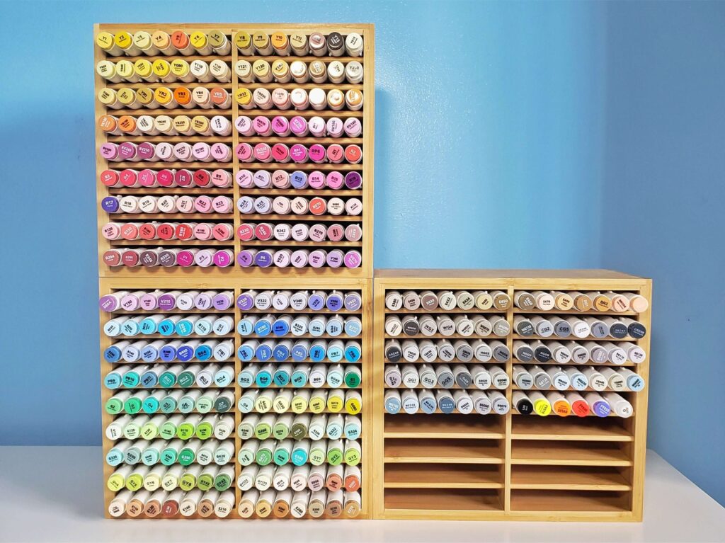 In the image are three bamboo organizers. The rows are filled with 320 colourful markers from the Ohuhu Honolulu set. Two organizers are stacked on one another, and the third is next to the other two.