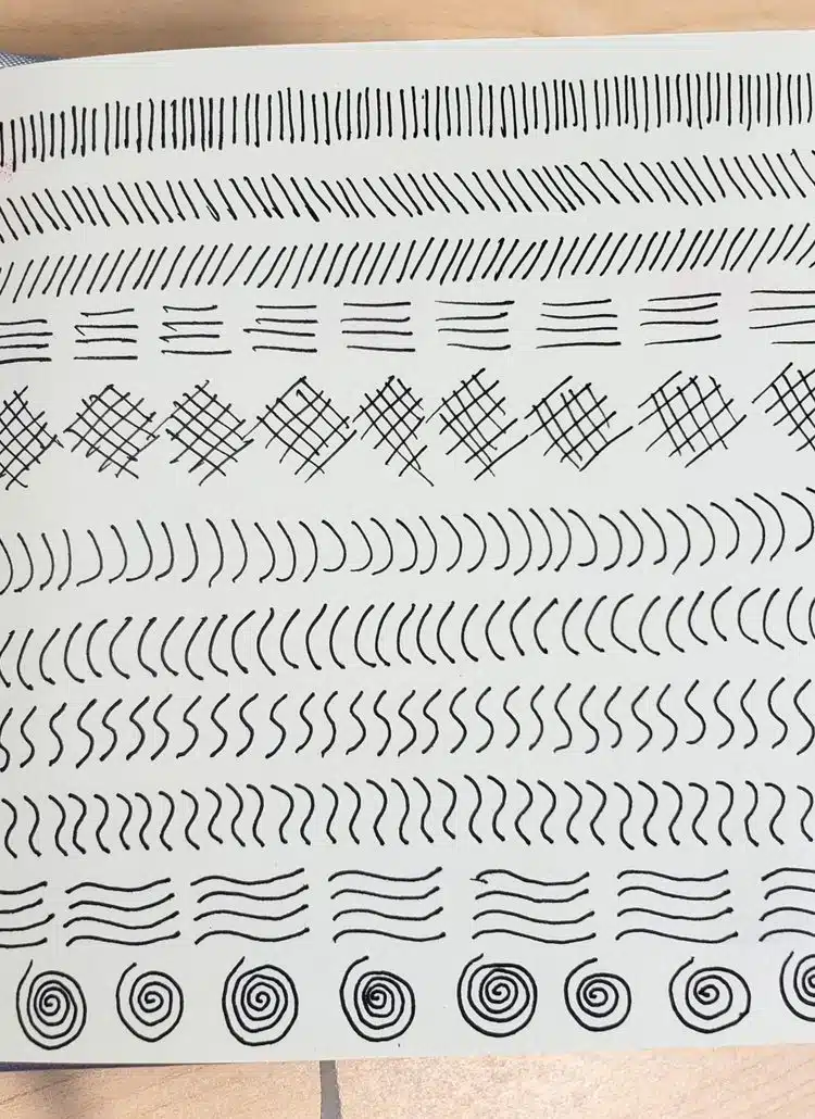 Learn how to fill a sketchbook page by taking a fineliner or pen and making simple marks such as lines, curves, and crosshatching.